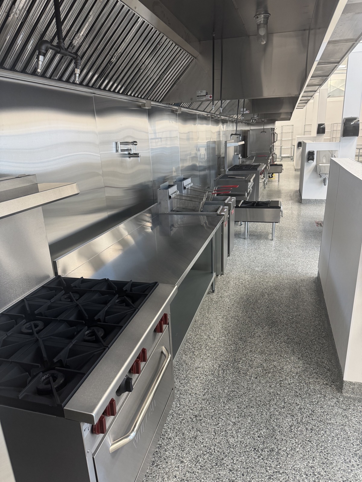 Gas ranges and flat top grills on the Langley commercial cookline