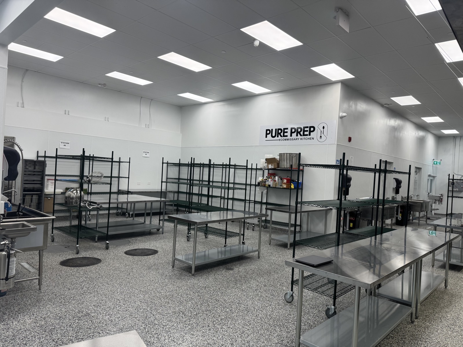 PurePrep branded production floor with prep tables and storage racks